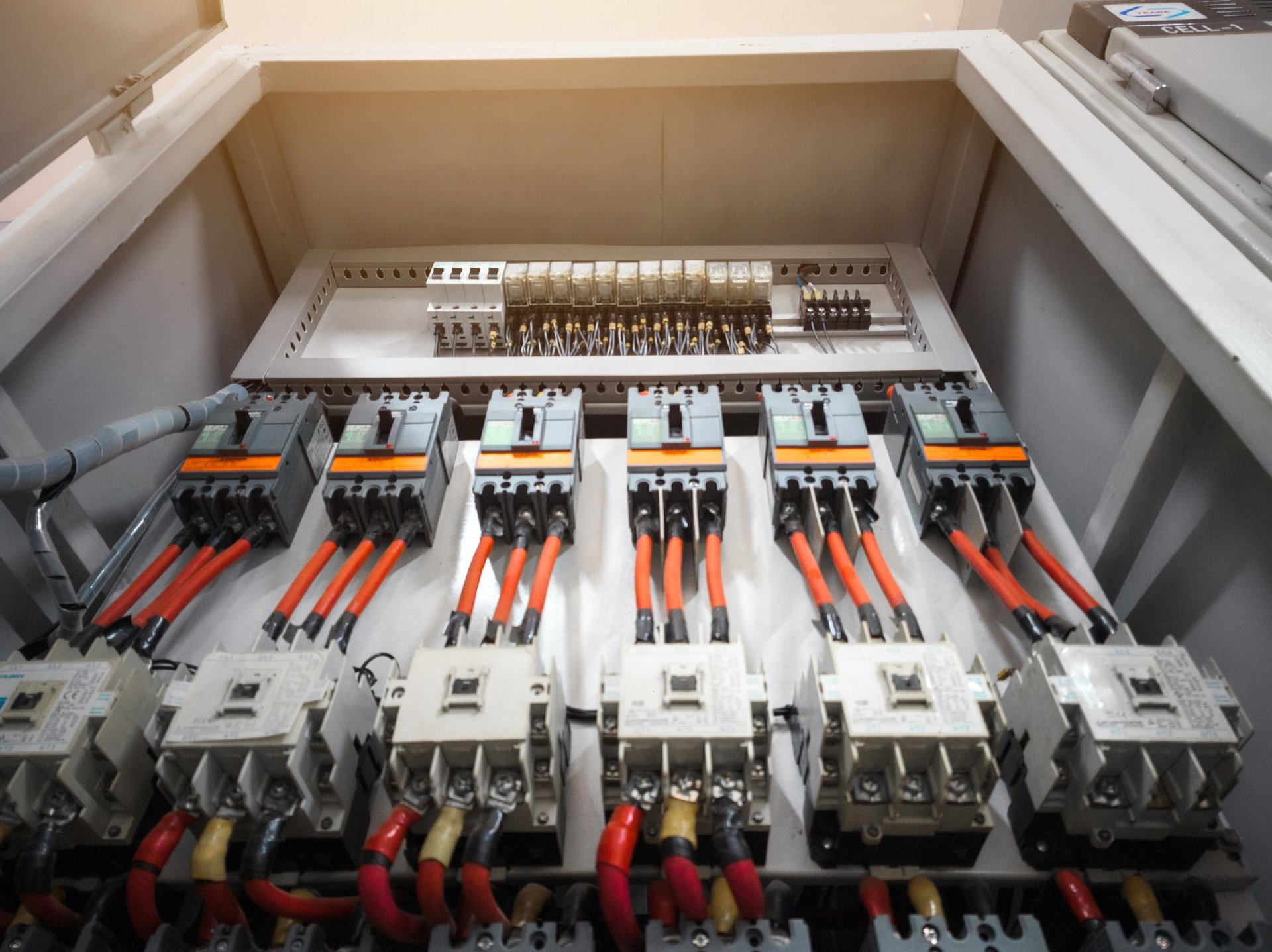 Professional master electrician performing industrial panel installation in Calgary